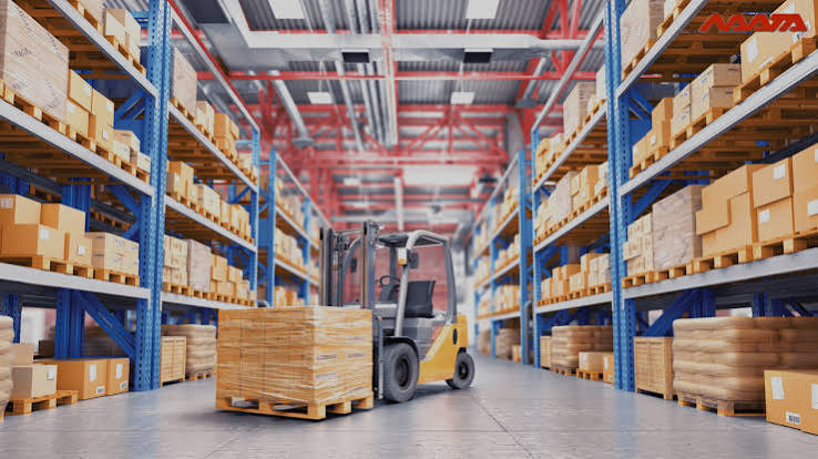 Forklift moving pallets through high-bay racking in a distribution center